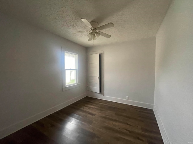 unfurnished room with a textured ceiling, ceiling fan, and dark hardwood / wood-style flooring