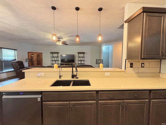 kitchen with sink, tasteful backsplash, stainless steel dishwasher, dark brown cabinets, and a textured ceiling