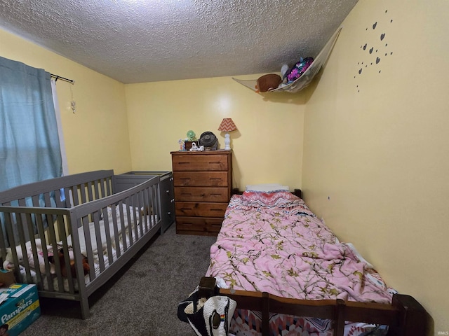 carpeted bedroom featuring a textured ceiling