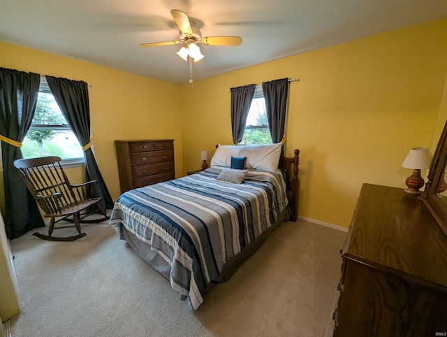 bedroom with light carpet and ceiling fan