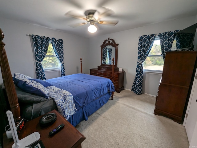 bedroom featuring ceiling fan and light colored carpet