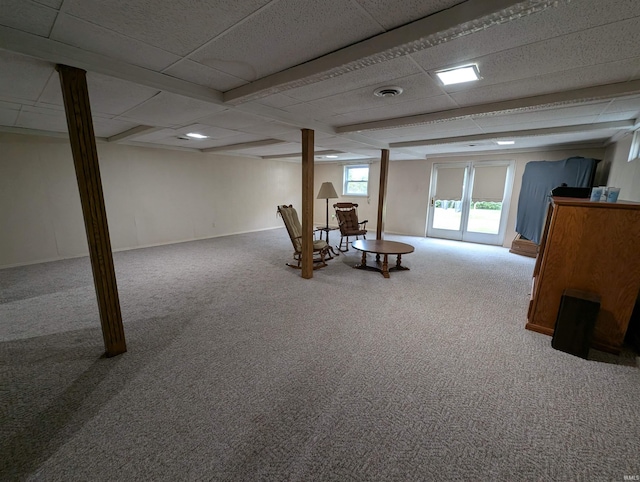 basement with a drop ceiling and carpet flooring