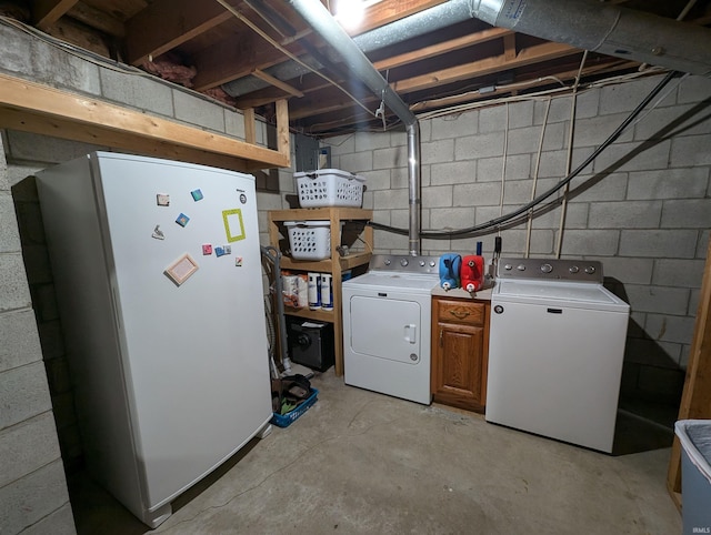 laundry room featuring separate washer and dryer and cabinets