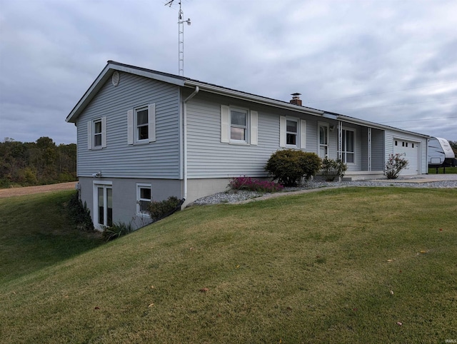 view of front of house with a front yard and a garage