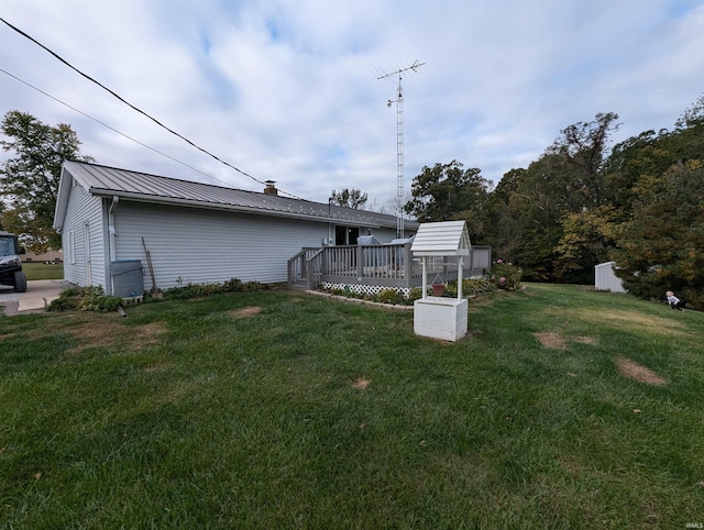 exterior space featuring a deck and a storage shed