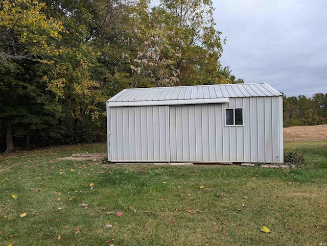 view of outbuilding with a yard