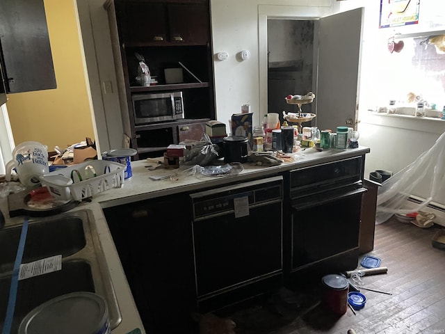 1002 High St, Logansport, IN 46947 - kitchen with stainless steel microwave, hardwood / wood-style flooring, dark cabinetry, water heater, and dishwasher