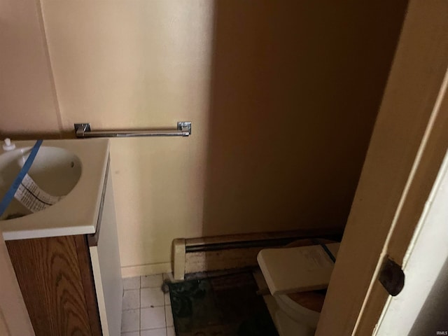 bathroom featuring tile patterned floors, toilet, and vanity