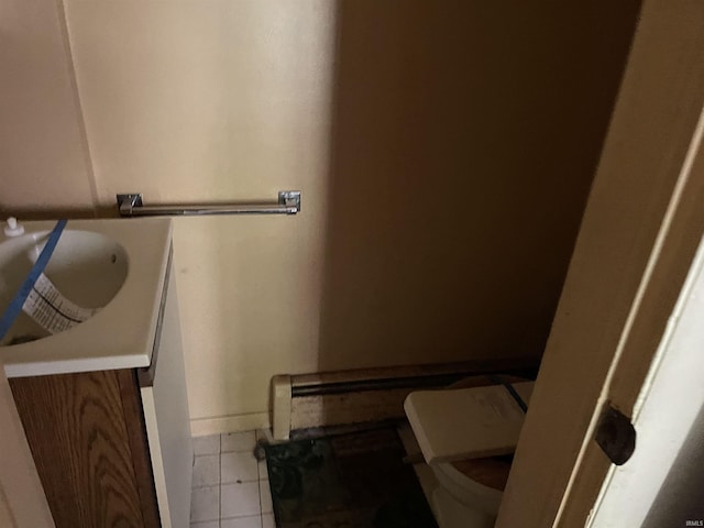 1002 High St, Logansport, IN 46947 - bathroom featuring tile patterned floors, baseboards, vanity, and toilet