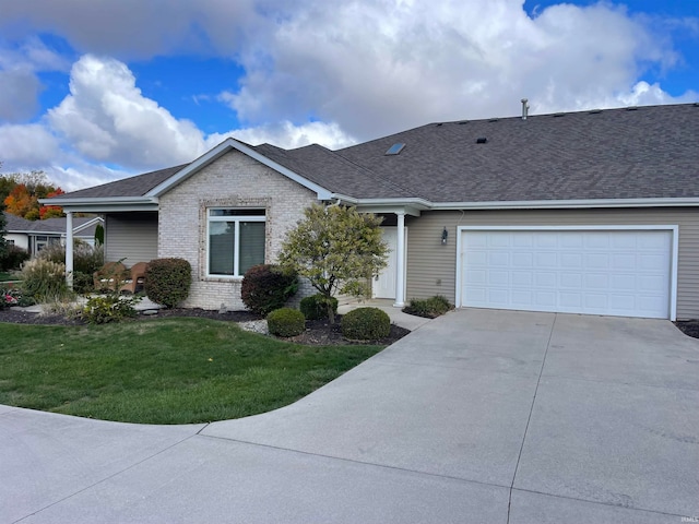 single story home with a garage and a front lawn