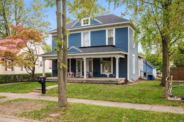 view of front facade with a front yard and a porch