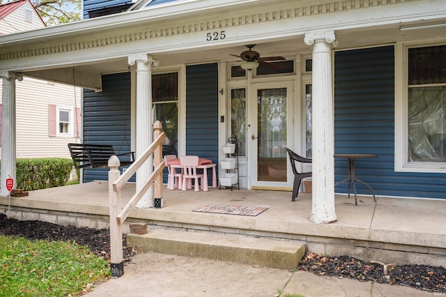 view of exterior entry featuring ceiling fan and covered porch