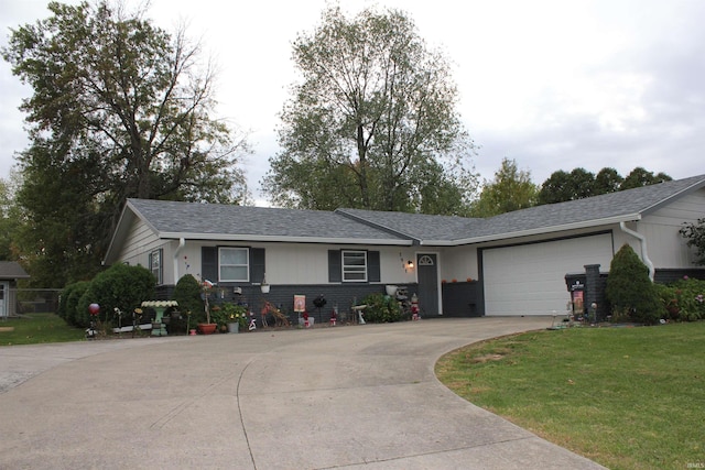 single story home featuring a garage and a front lawn