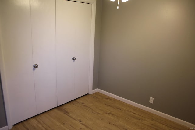 unfurnished bedroom featuring a closet and light hardwood / wood-style floors