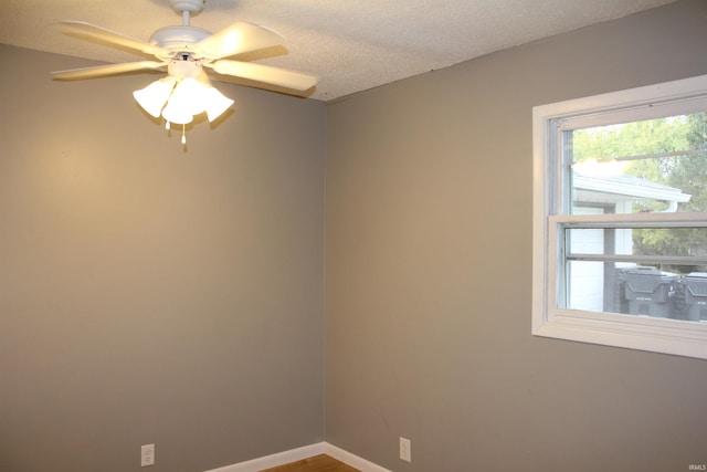 unfurnished room featuring ceiling fan and a textured ceiling