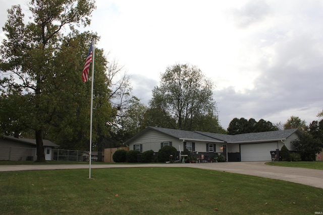 ranch-style house featuring a garage and a front lawn