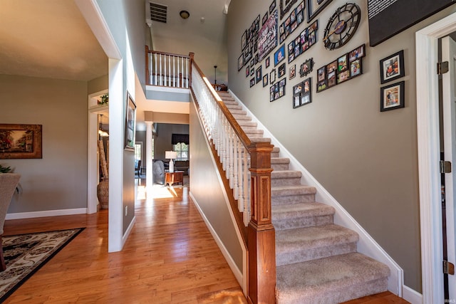 stairs with hardwood / wood-style flooring