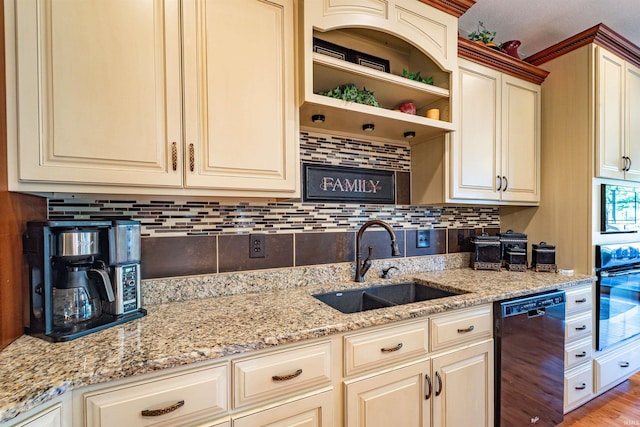 kitchen featuring sink, cream cabinets, light hardwood / wood-style flooring, black appliances, and light stone countertops