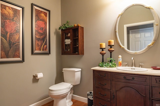 bathroom featuring hardwood / wood-style floors, vanity, and toilet