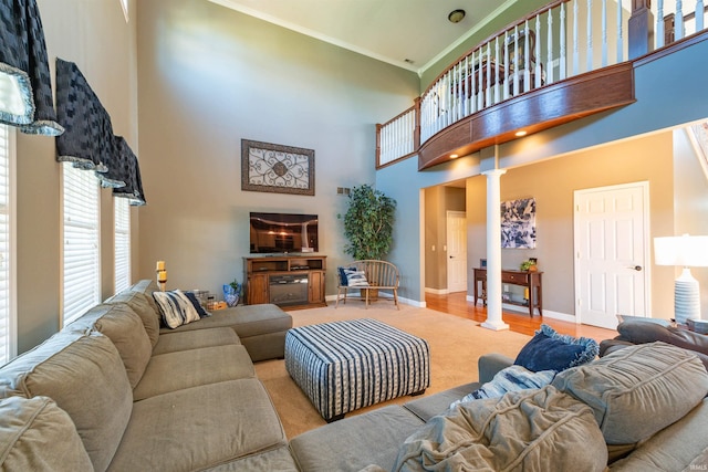 carpeted living room featuring decorative columns and a high ceiling