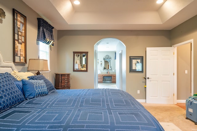 carpeted bedroom featuring a tray ceiling