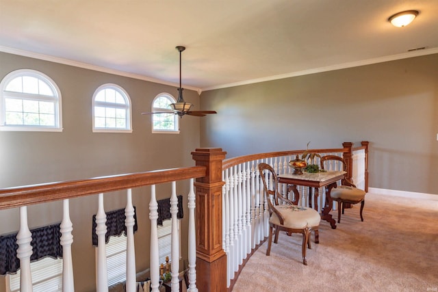 staircase with ceiling fan, ornamental molding, and carpet flooring