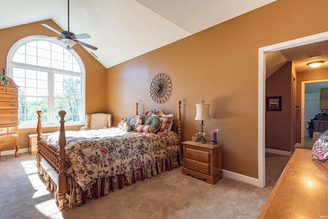 bedroom featuring multiple windows, ceiling fan, vaulted ceiling, and light colored carpet