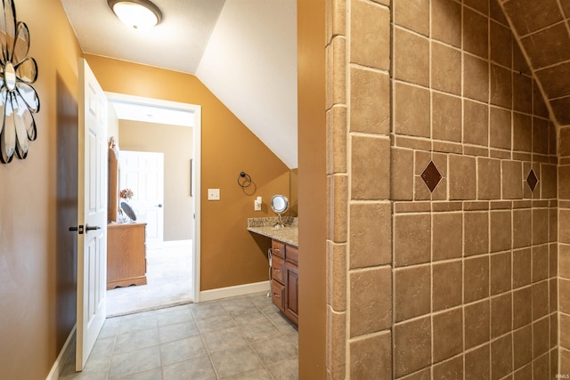 bathroom with vanity and lofted ceiling