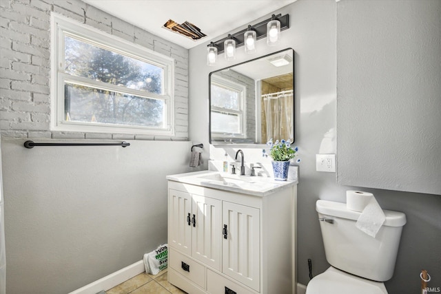 bathroom featuring vanity, tile patterned flooring, and toilet