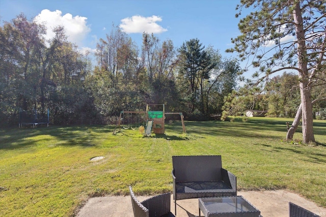 view of yard featuring a trampoline and a playground