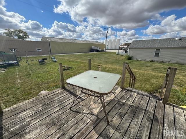 wooden deck with a lawn