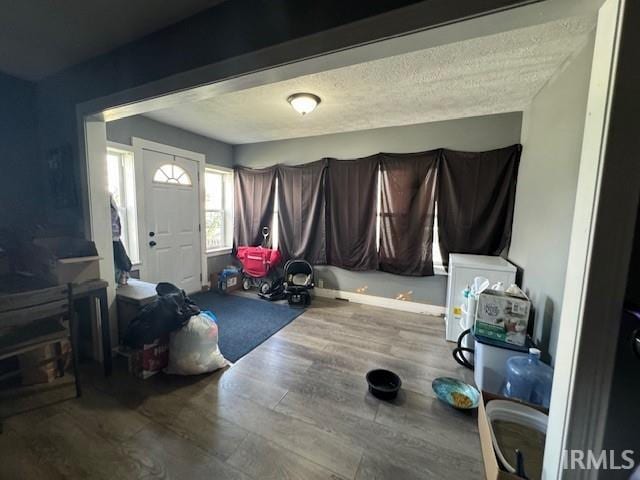 interior space featuring hardwood / wood-style flooring and a textured ceiling