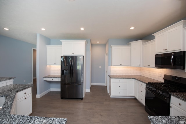 kitchen featuring dark hardwood / wood-style floors, white cabinets, appliances with stainless steel finishes, and backsplash