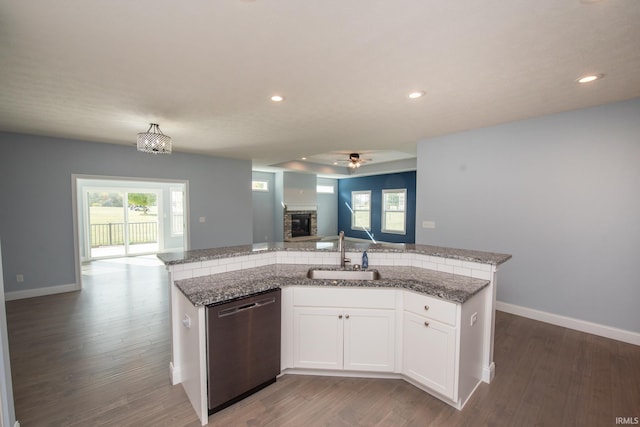 kitchen featuring white cabinets, sink, dark hardwood / wood-style flooring, and stainless steel dishwasher