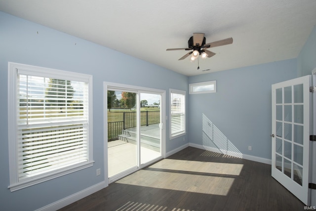 spare room featuring french doors, dark hardwood / wood-style floors, and ceiling fan