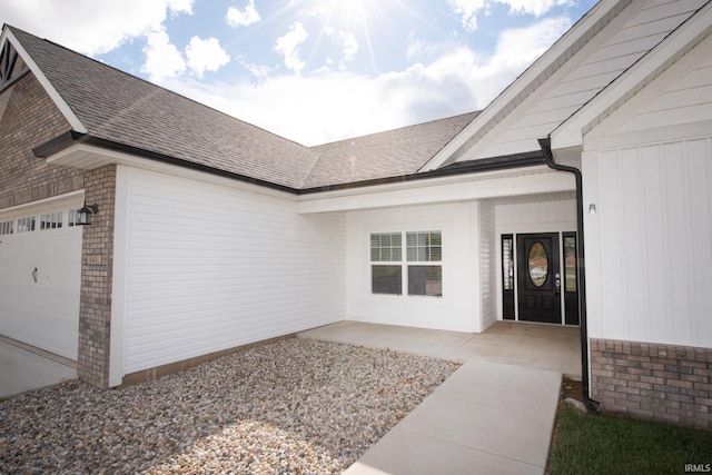 doorway to property with a garage