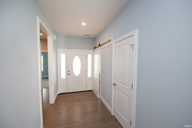 doorway featuring a barn door and wood-type flooring