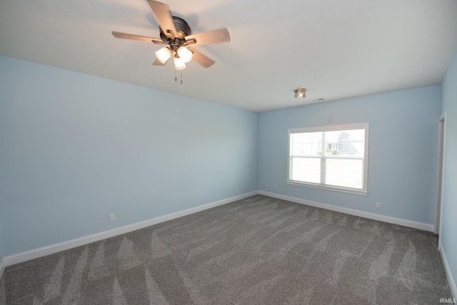 carpeted spare room featuring ceiling fan