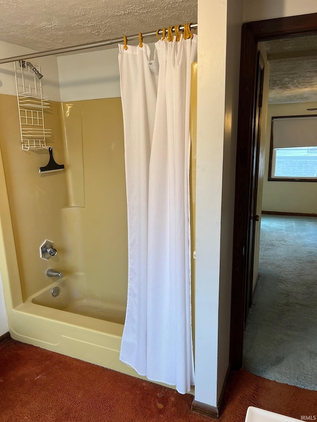 bathroom featuring shower / bathtub combination with curtain and a textured ceiling