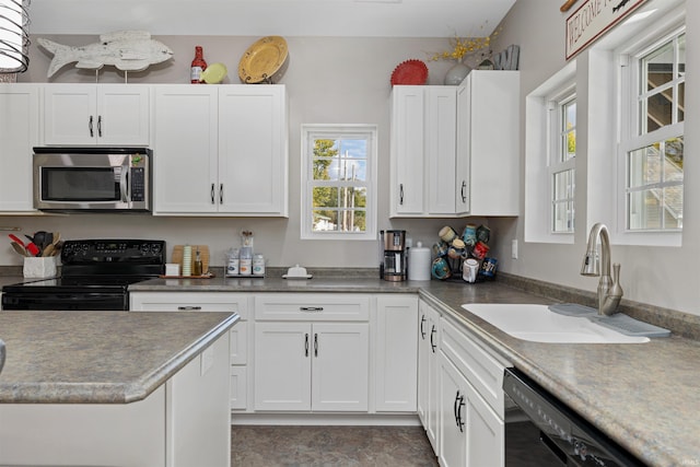 kitchen with white cabinetry, dishwashing machine, sink, and black range with electric stovetop