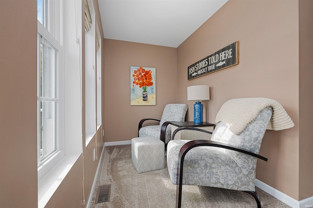 living area with light colored carpet and a healthy amount of sunlight