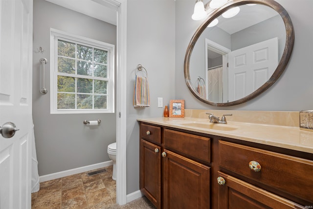 bathroom with vanity and toilet