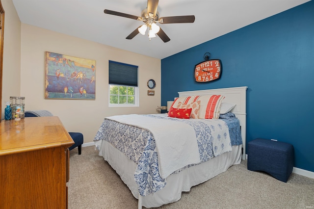 bedroom featuring light carpet and ceiling fan