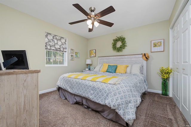 bedroom featuring ceiling fan, a closet, and dark colored carpet