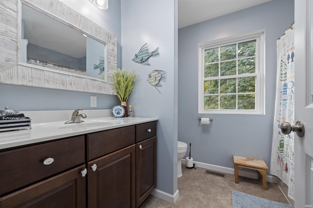 bathroom featuring vanity and toilet