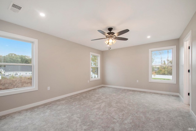 unfurnished room featuring ceiling fan and light colored carpet