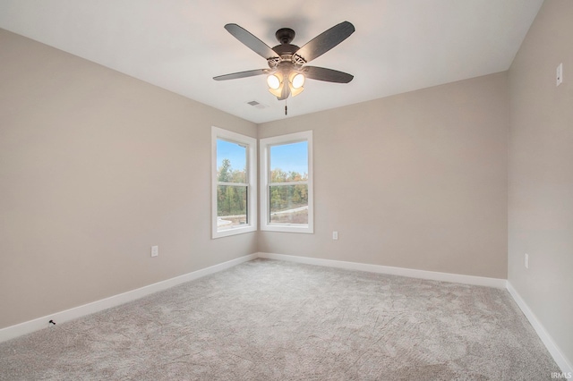 carpeted spare room featuring ceiling fan