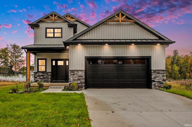 craftsman-style house featuring a garage, a lawn, and covered porch