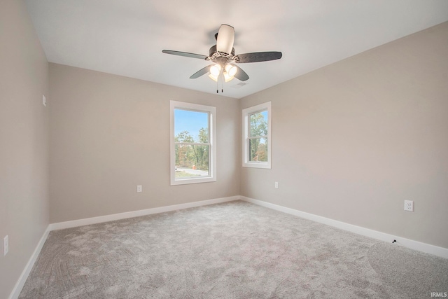 carpeted empty room featuring ceiling fan