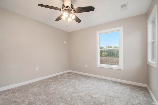 carpeted spare room with ceiling fan